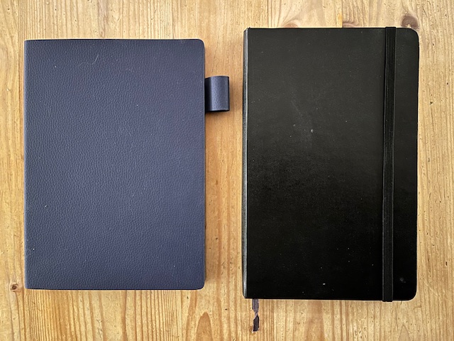 A Supernote and a Moleskine Notebook next to each other.